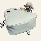 Halloween cartoon ghost shaped white bag with black eyes on gray surface