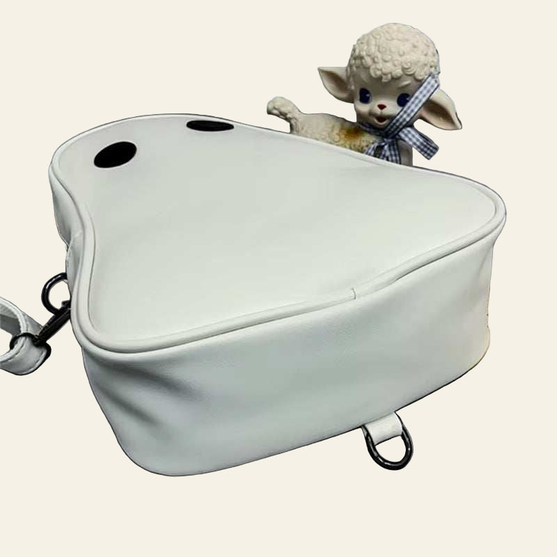 Halloween cartoon ghost shaped white bag with black eyes on gray surface