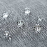 Close-up of water droplets on grey Oxford fabric showcasing waterproof feature of passport holder
