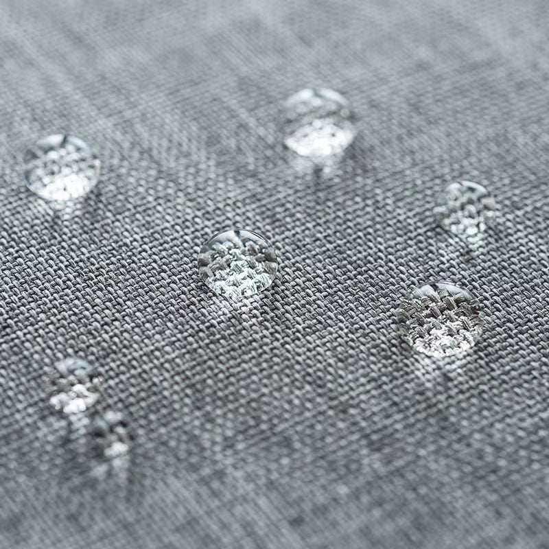 Close-up of water droplets on grey Oxford fabric showcasing waterproof feature of passport holder
