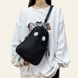 Black Halloween cartoon ghost-shaped crossbody bag with white eyes worn with white oversized sweatshirt