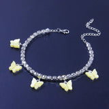 Silver anklet with yellow butterfly charms and rhinestones on dark background butterfly charms anklets