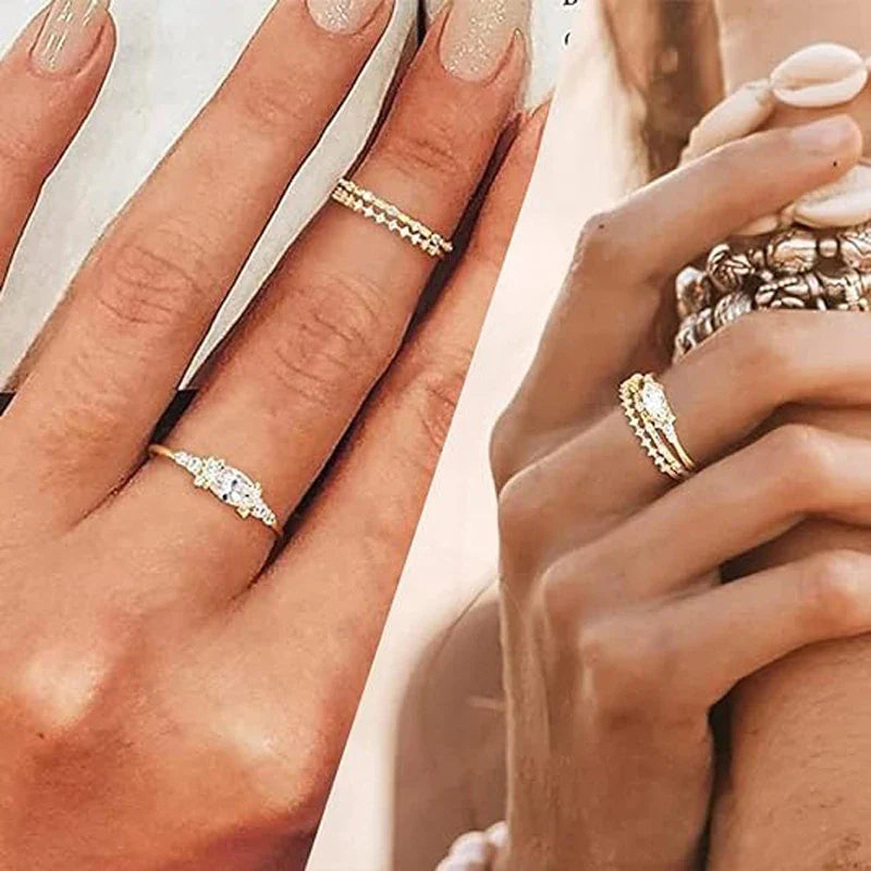 close-up of hands wearing elegant stackable gold rings with cubic zirconia gemstones