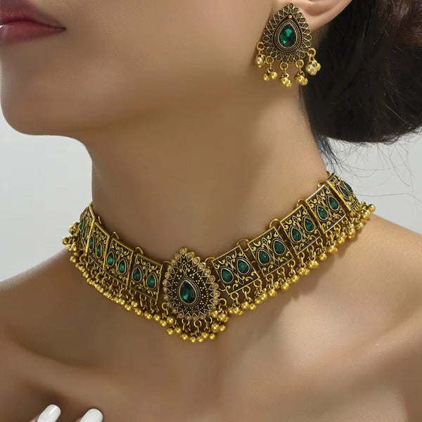 Vintage gold-tone jewelry set with green gemstone detailing, featuring a choker necklace and matching earrings.